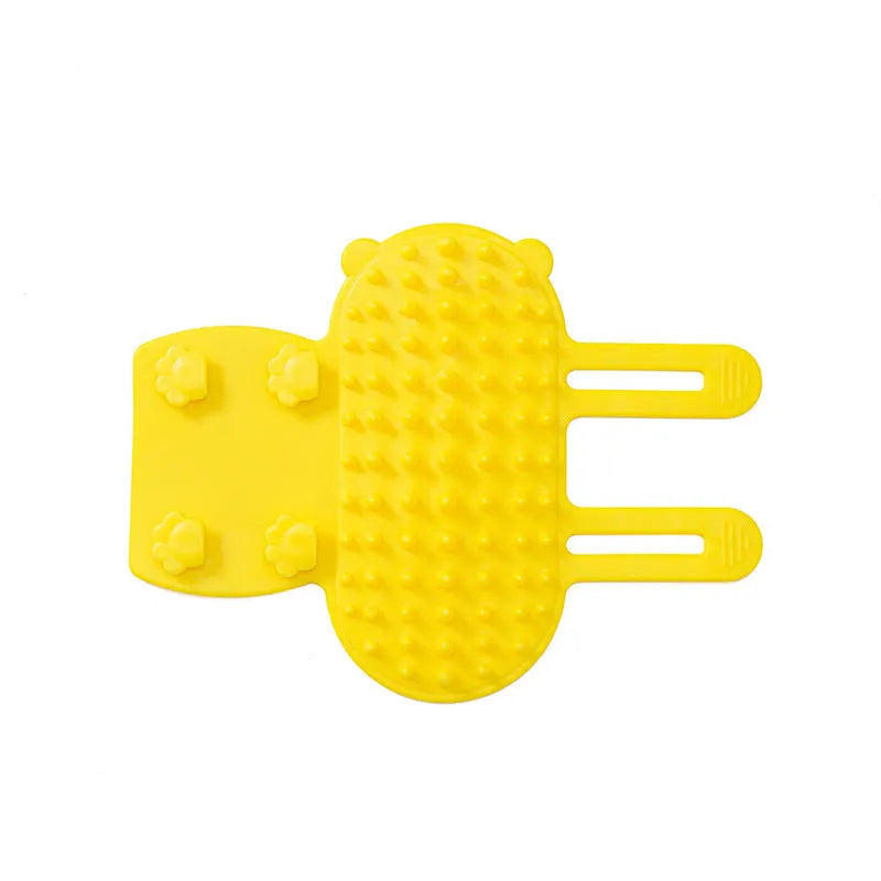 Silicone cat self-grooming brush with comb teeth and adjustable strap for table legs.