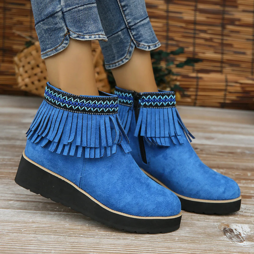 Women's dark brown suede wedge bootie with thick sole, side zipper, and tassel detail.
