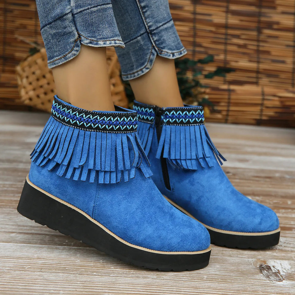 Women's dark brown suede wedge bootie with thick sole, side zipper, and tassel detail.