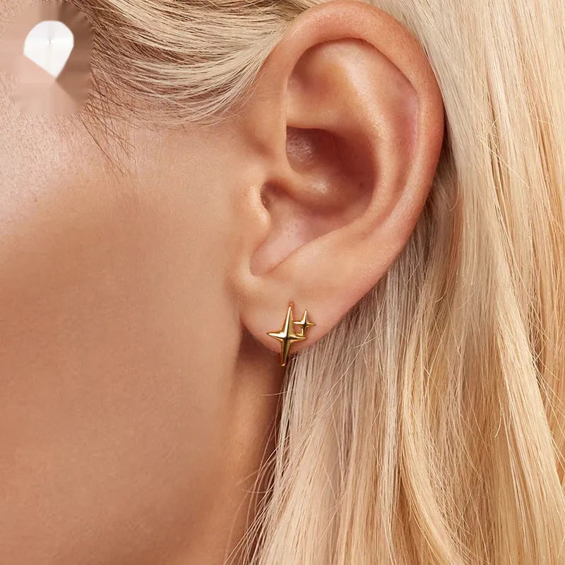 Sterling silver star clip earrings with oxidised finish and XINGX design details