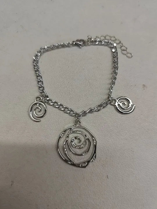 Women's spiral donut jewellery set showing bracelet, earrings, and adjustable necklace in gold tone