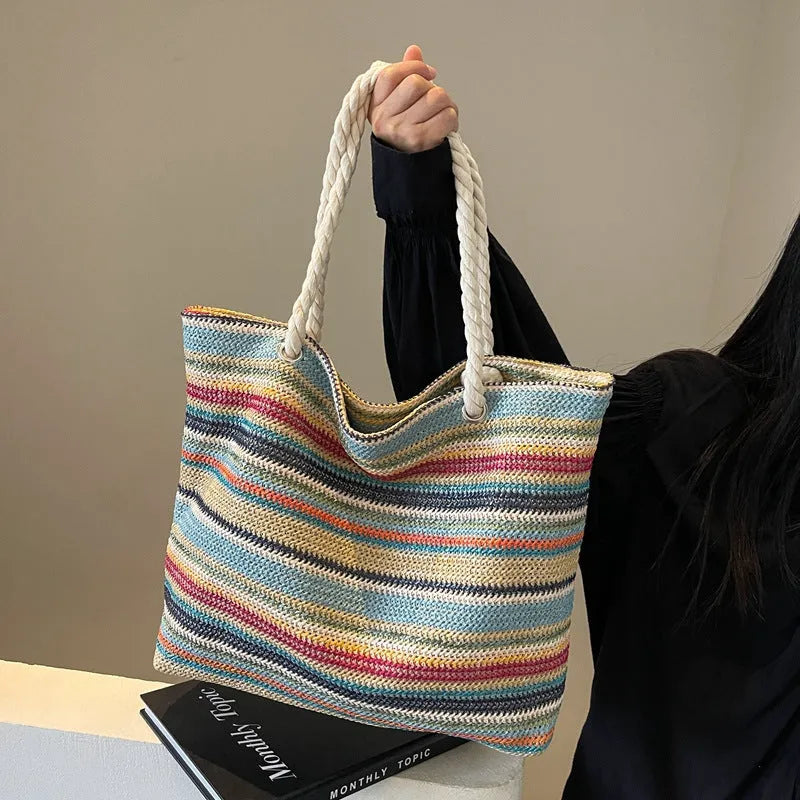 Blue straw woven large capacity nylon shoulder bag with a single strap.