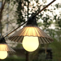 Outdoor LED string lights with flower-shaped bulbs in garden setting showing IP65 waterproof rating