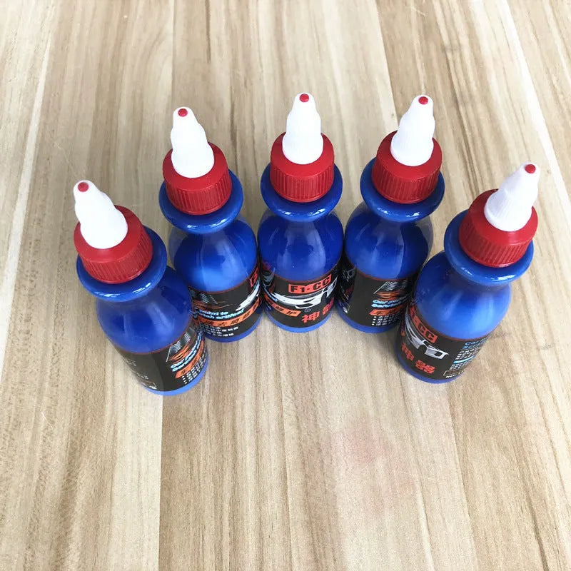 Small blue bottle of 30ml car scratch repair agent with applicator brush for automotive paint touch-ups