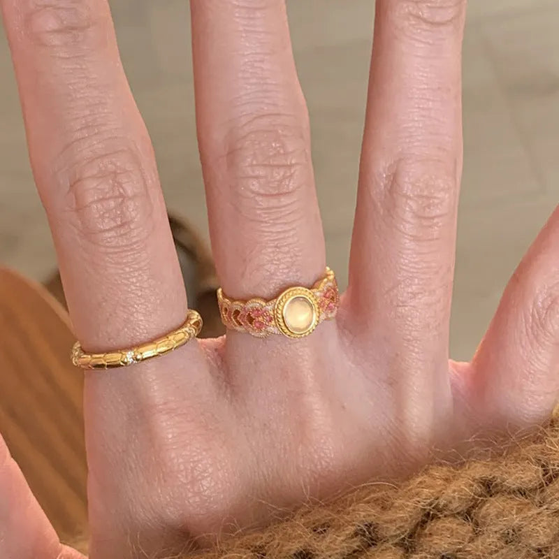 Geometric pink crystal enamel open ring for women on a copper band with gold plating.