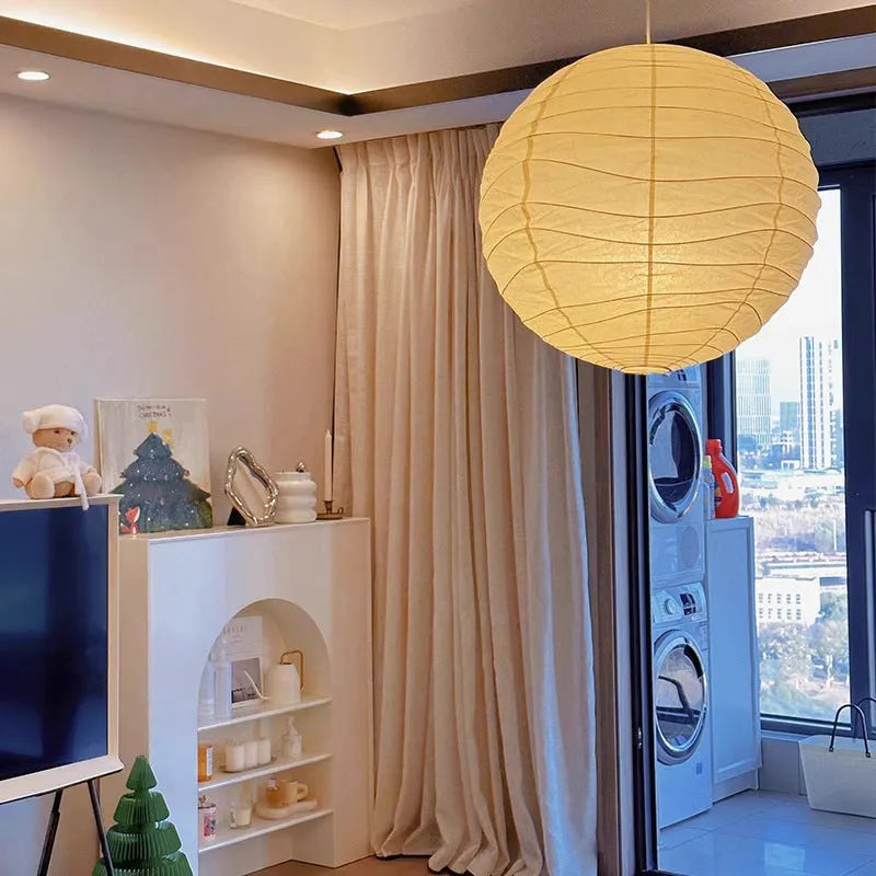 Japanese style white rice paper pendant chandelier with a woven frame, shown in a room setting.