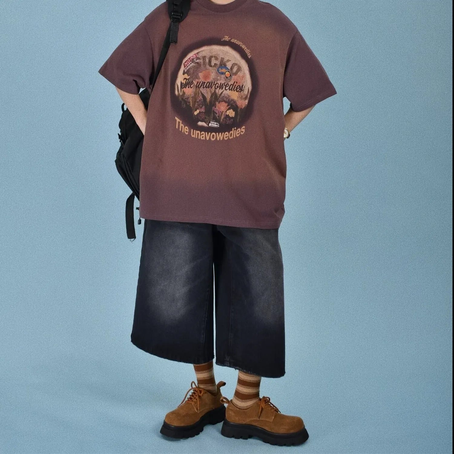 Men's loose-fit straight-leg denim shorts in blue, shown on a model for summer.