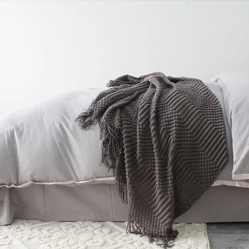 Small light grey polyester nap blanket folded, showing its 127cm by 170cm size.