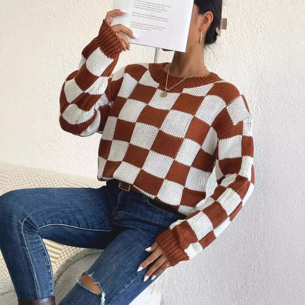Dark brown plaid loose round neck acrylic pullover sweater on a hanger