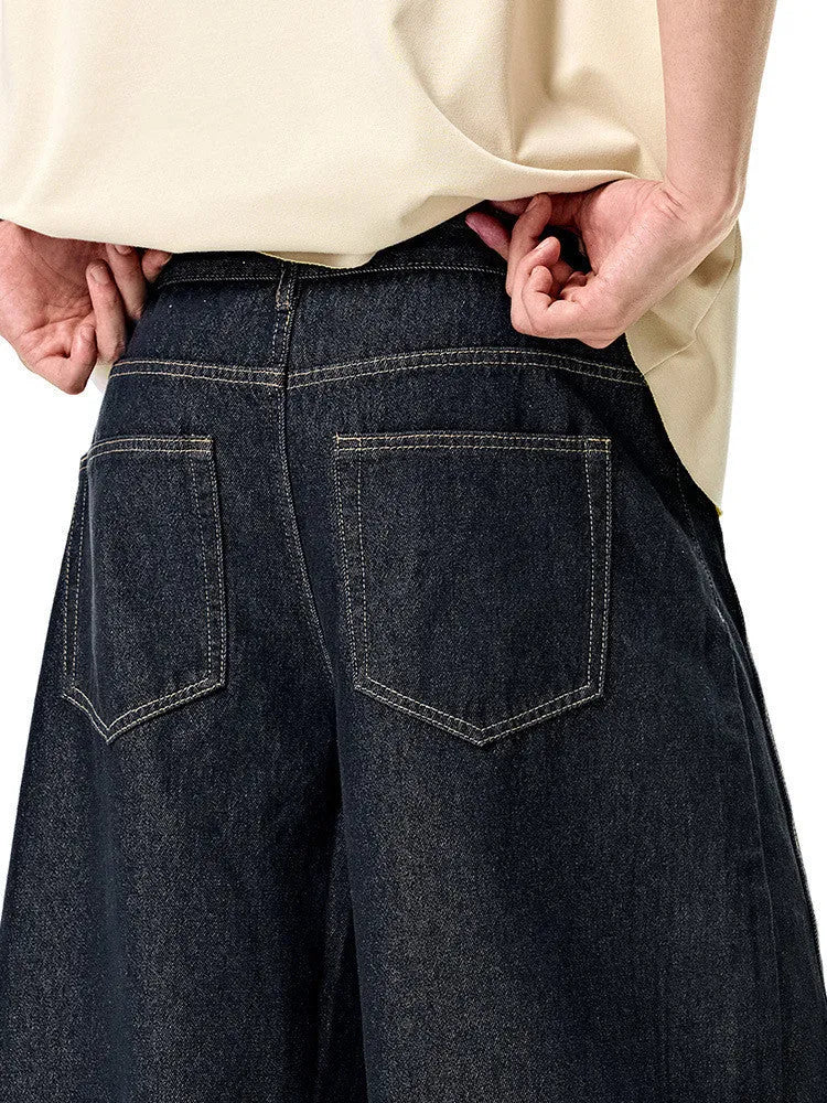 Men's original cow colour wide leg denim trousers with a mid-waist, laid flat.