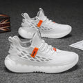 Men's low-top white mesh sneakers with a rubber sole and round toe on a plain background.