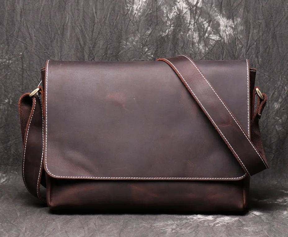 Brown vintage leather men's messenger bag with a flap opening and an adjustable shoulder strap.