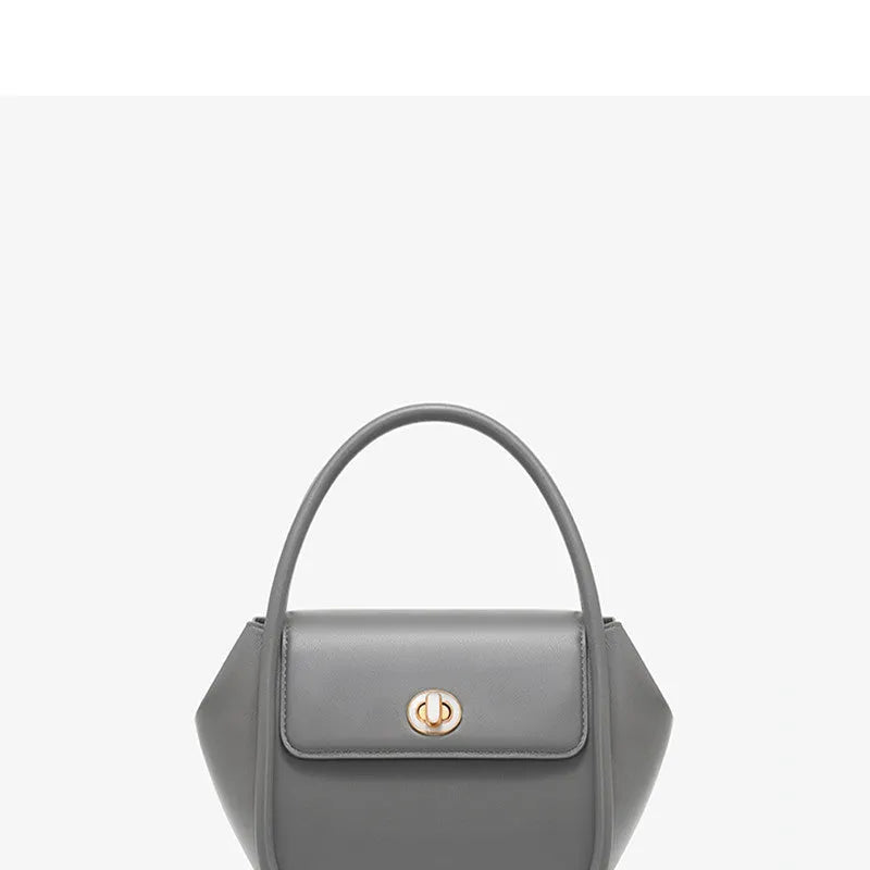 A soft cow leather wing-shaped tote handbag with a buckle and shoulder strap in black.