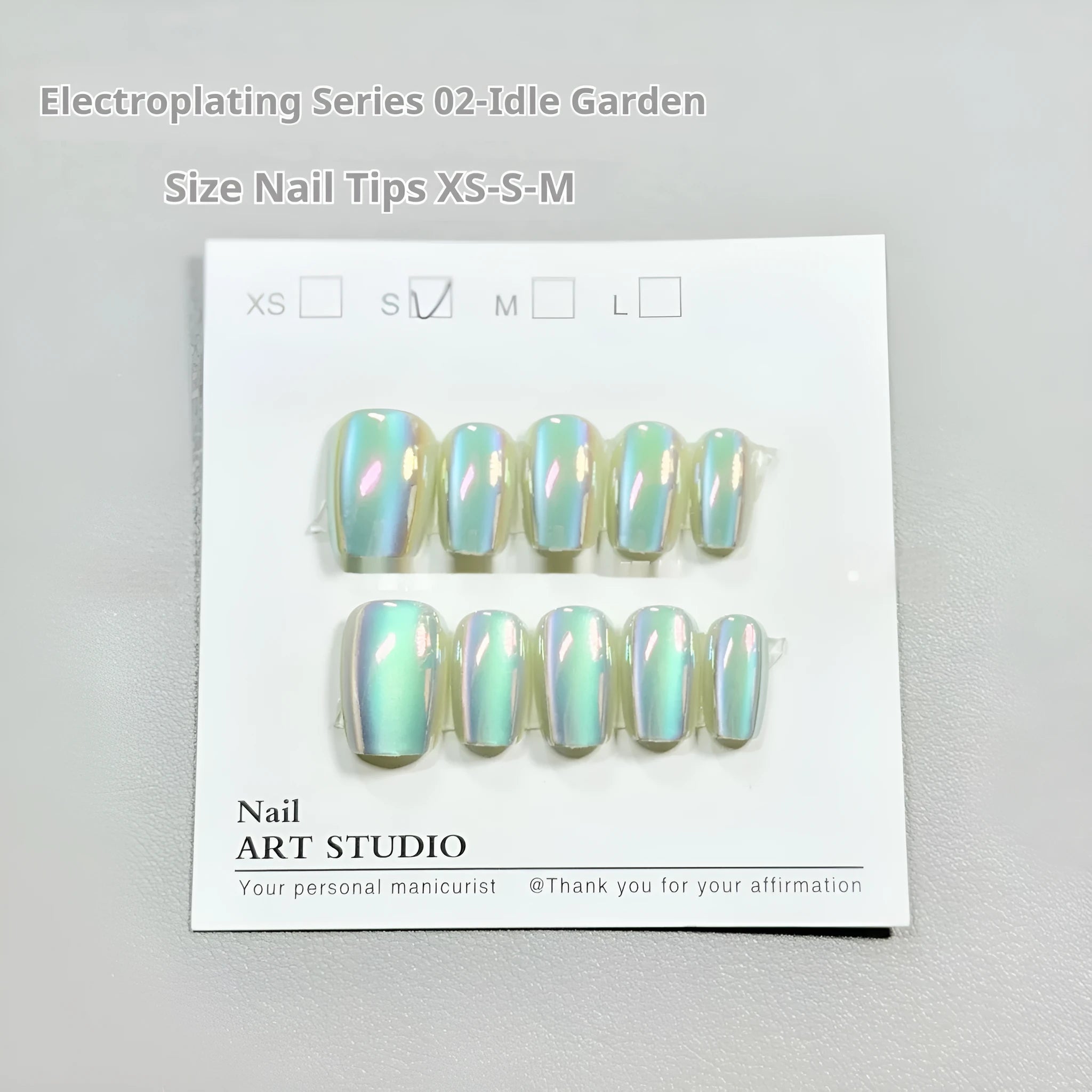 Electroplated Cat's Eye false nail set showing Aurora, solid colour, and gemstone-effect styles in short ladder sizes.