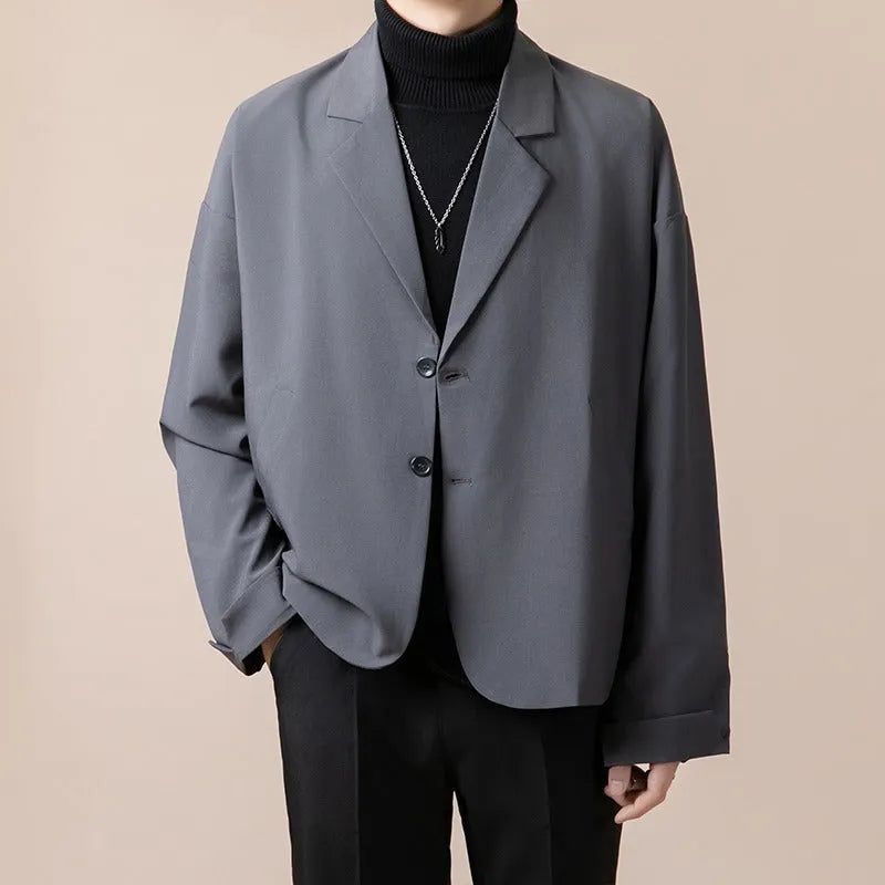Man wearing a loose fit casual suit jacket in a light business style, available in multiple colours.