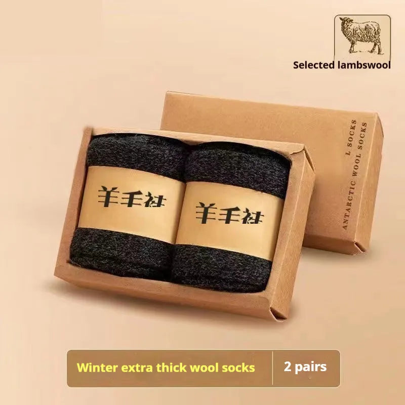 Two pairs of thick grey winter wool socks with a merino midsole next to a storage box