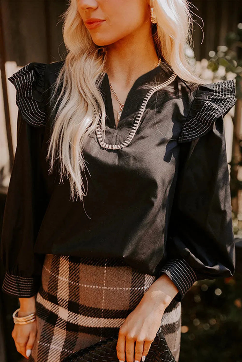 Black women's V-neck blouse with contrast stitching and ruffle long sleeves