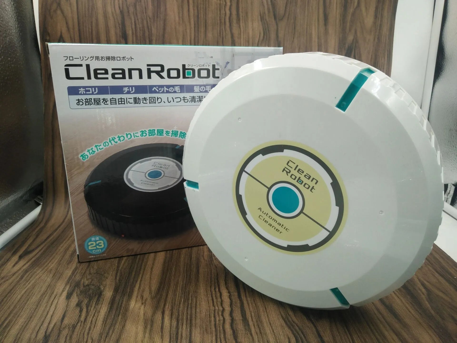 AC robot vacuum cleaner in black or white on wooden floor