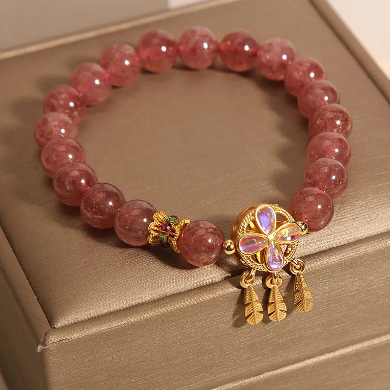 Women's strawberry quartz crystal bracelet with four leaf dream catcher ball pendant in natural rose pink colouration