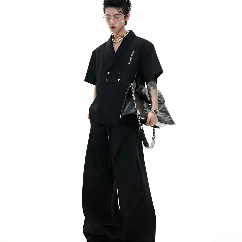 Men's dark grey cotton sports suit with metal embellishments, V-neck padded shoulders, short sleeves, and matching shorts