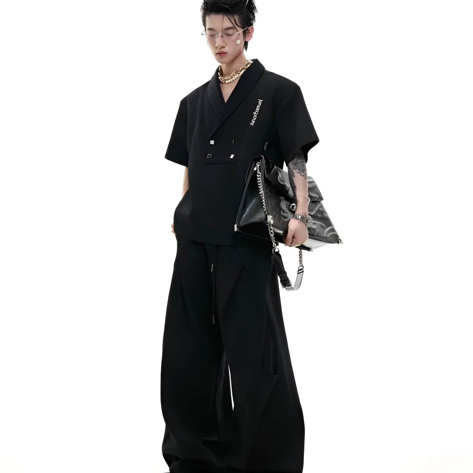 Men's dark grey cotton sports suit with metal embellishments, V-neck padded shoulders, short sleeves, and matching shorts