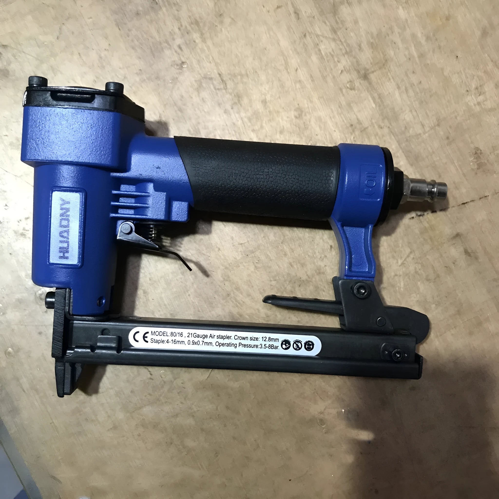 Blue pneumatic strip nail gun with American connector for decoration and upholstery work