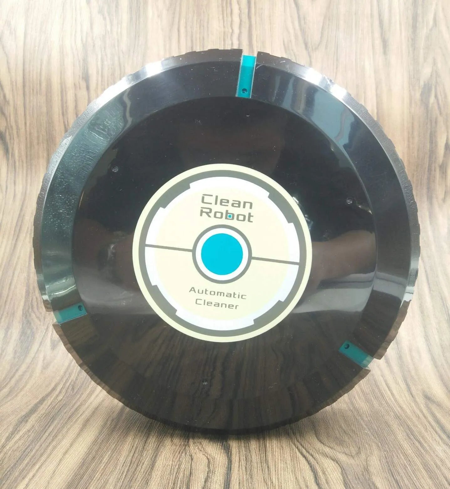 AC robot vacuum cleaner in black or white on wooden floor