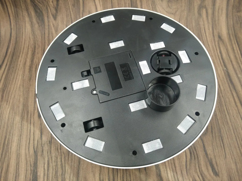 AC robot vacuum cleaner in black or white on wooden floor