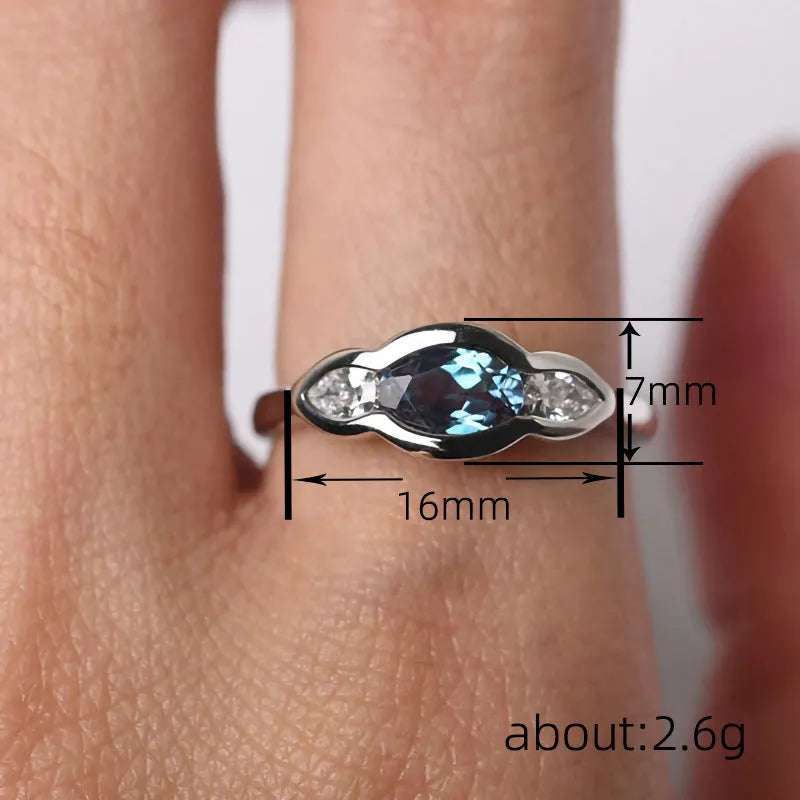 Geometric ellipse ring with zircon inlay in white gold colour on copper