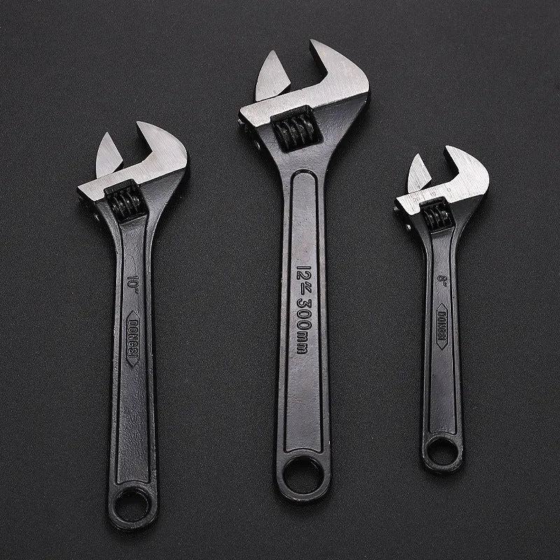 Stainless steel adjustable open-end wrench with blackened finish showing adjustment mechanism and four size options