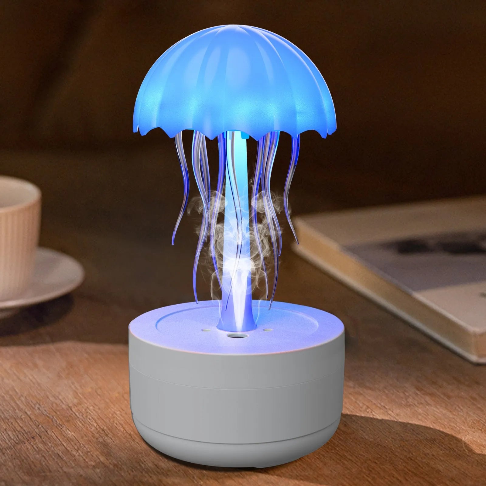 White jellyfish-shaped humidifier and essential oil diffuser with colourful LED night light on a desktop.