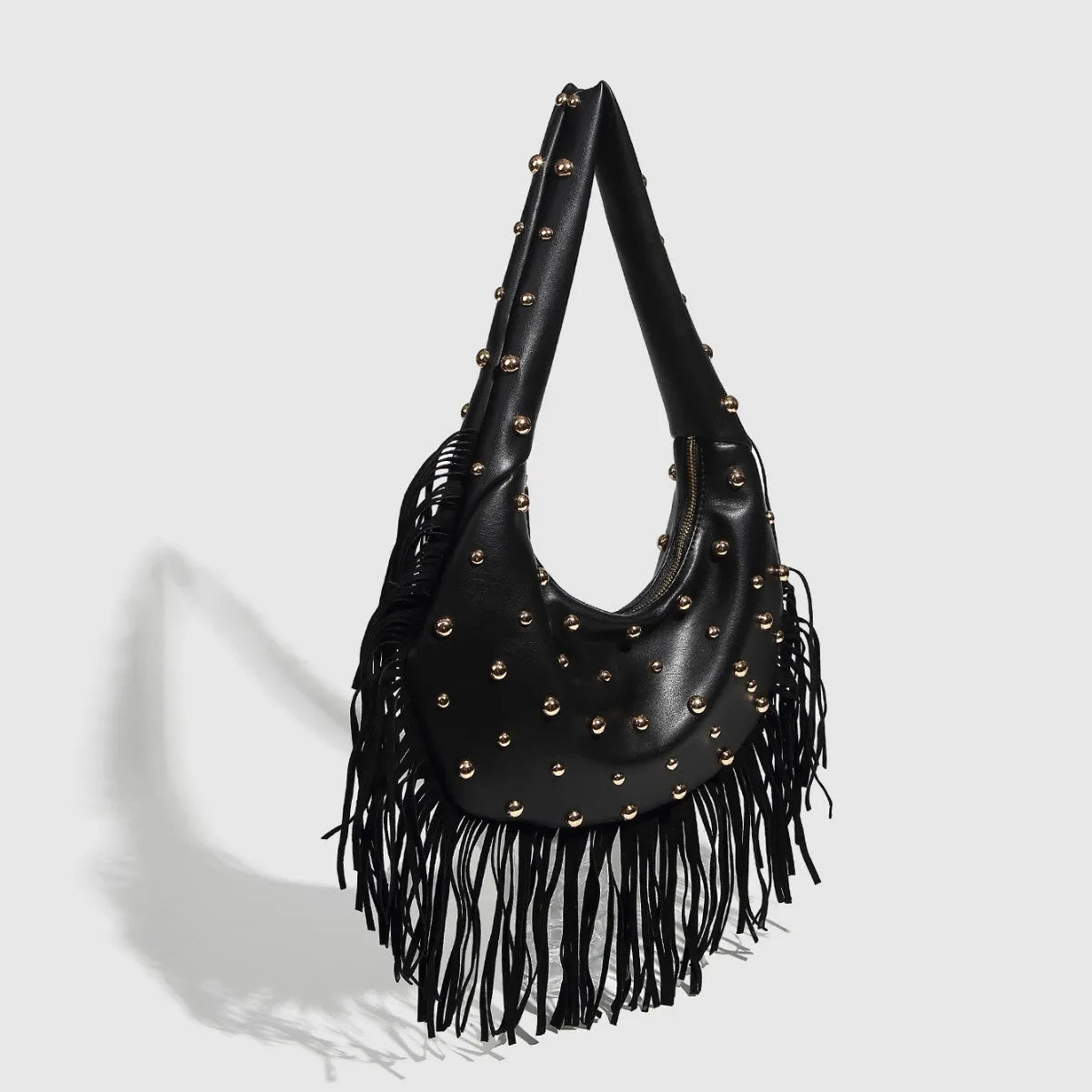 Black retro shoulder handbag with a tassel and an internal mobile phone compartment.