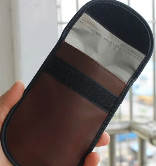 Black microfiber Faraday cage bag for blocking car key fob and RFID signals.