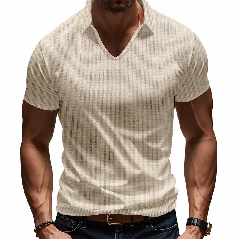 Man wearing a loose-fit apricot coloured V-neck short sleeve cotton blend T-shirt.