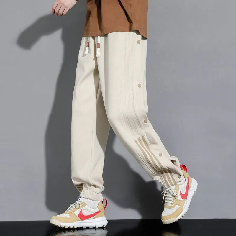 Men's loose fit cotton blend sports pants with high waist and ankle-tied cuffs in solid colours