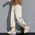 Men's loose fit cotton blend sports pants with high waist and ankle-tied cuffs in solid colours