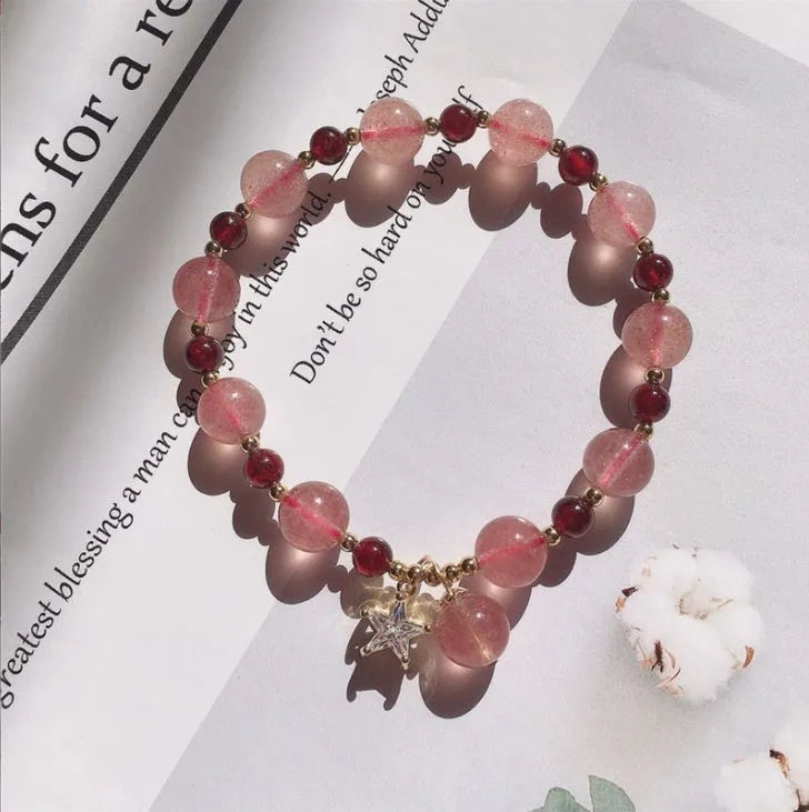 Adjustable strawberry quartz bracelet with Hetian jade peach blossom charm on wrist