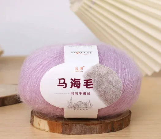Single ball of mohair yarn in various colours for hand-woven DIY scarf knitting projects