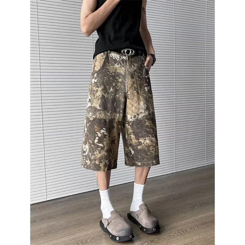 Yellow women's cropped jeans with a large snake camouflage pattern tooling print on the denim fabric.