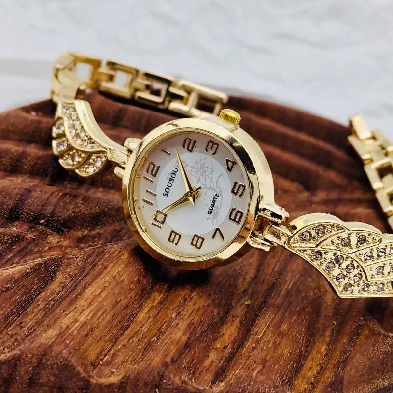 Women's stainless steel fashion watch with round gold dial and vachette clasp.