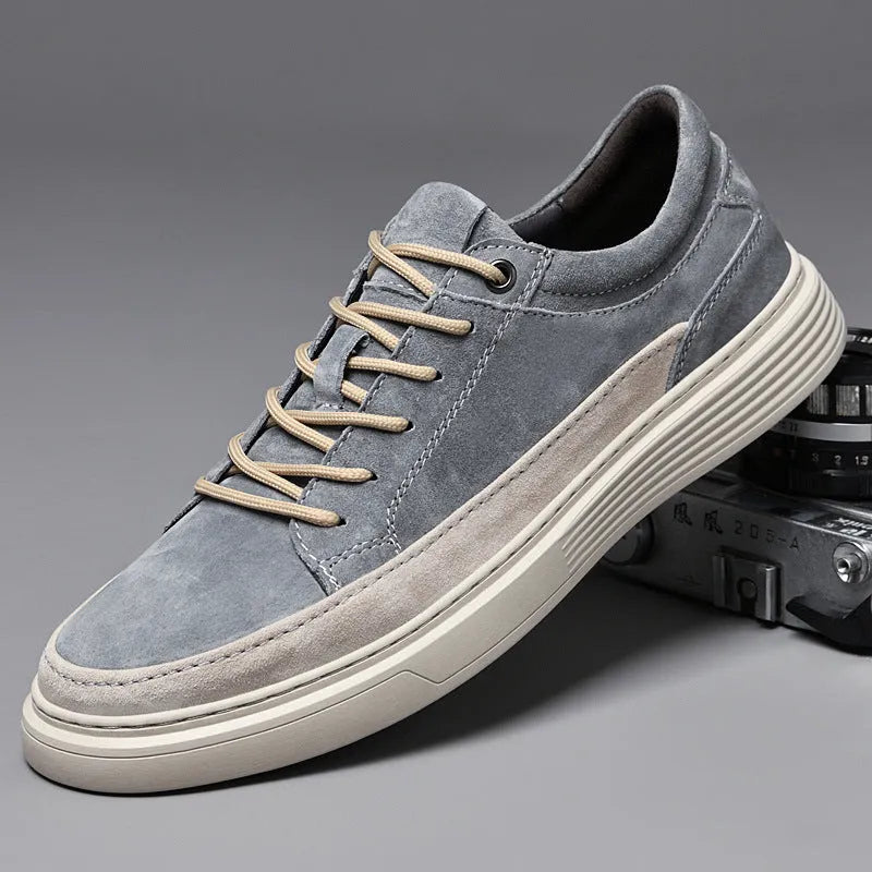 Men's gray casual skate shoes with pigskin leather upper and rubber sole on a white background.