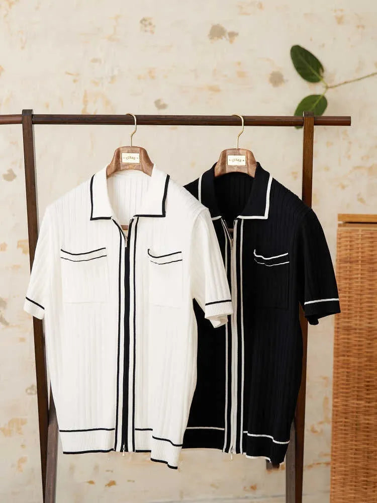 Man's slim fit black knitted polo shirt with lapel collar and short sleeves on a hanger.