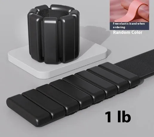 A black silicone weight-bearing bracelet with Velcro fastening, shown with 1lb and 2lb weight options.