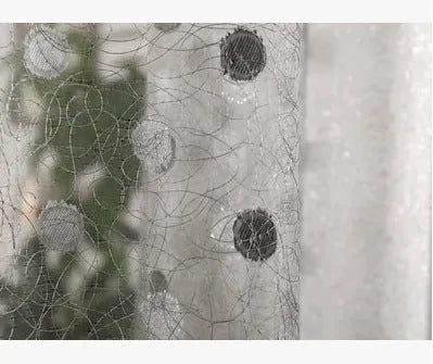 Simple blackout curtain panel hanging, showing light-blocking fabric and hook heading style.