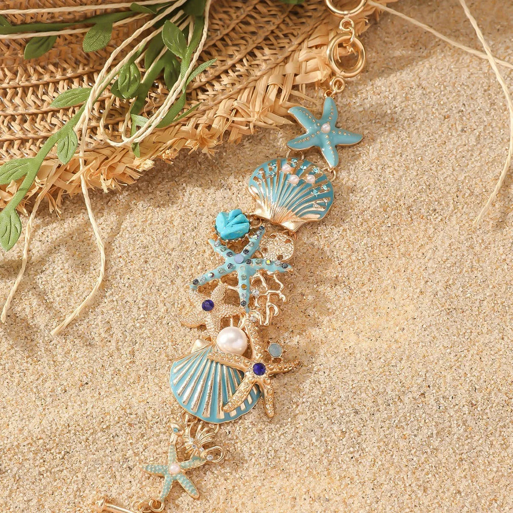 Women's alloy rhinestone bracelet with boat anchor, shell, and starfish charms in blue.