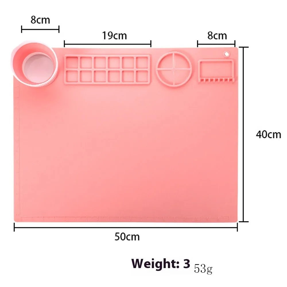 Light blue silicone painting mat with two round bowls on a 50cm by 40cm rectangular surface.
