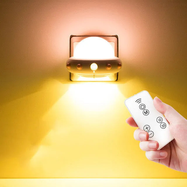 Remote control UFO shaped bedside night light in blue, pink, or white colour.