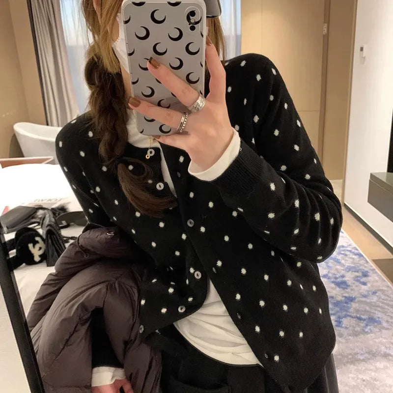 Women's grey dot pattern knitted cardigan with crocheted flower detail and long sleeves
