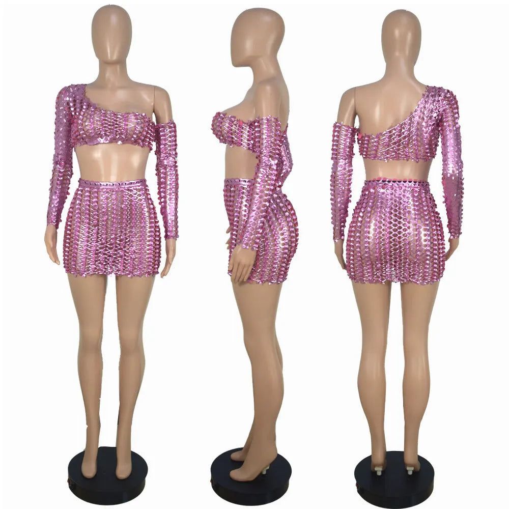 Women's black hollow-out two-piece set featuring a sleeveless top and short skirt with splicing detail.