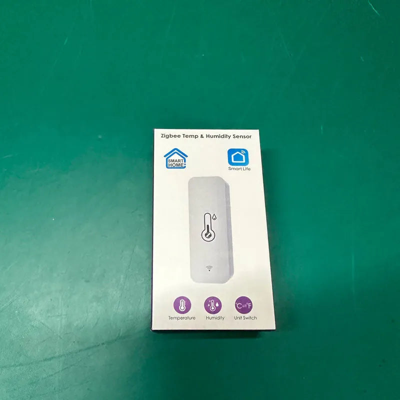 White WiFi and Zigbee smart temperature and humidity sensor on a table